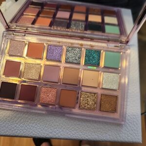 HUDA BEAUTY Eyeshadow Palette with Purple, Teal, and Gold Hues